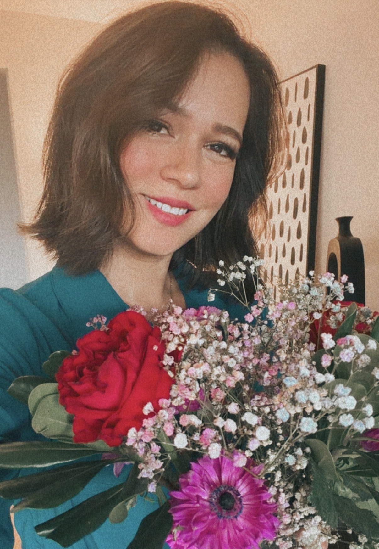 Samantha Michelle smiling and holding a colorful bouquet